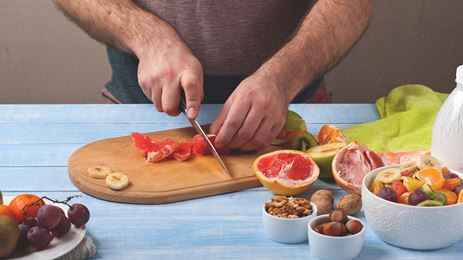 man chopping fruit and vegetables