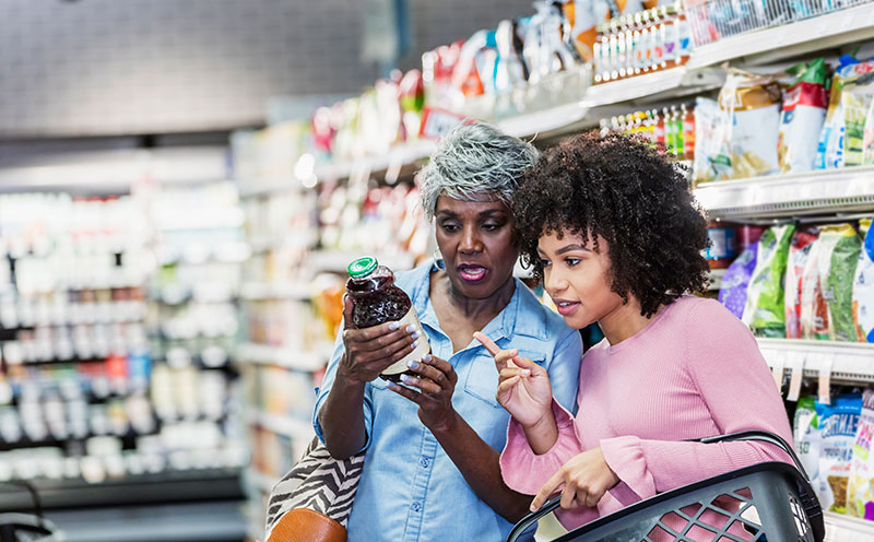 women reading grocery label