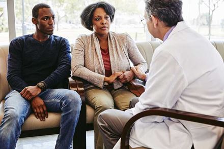 Doctor talking to woman and her son