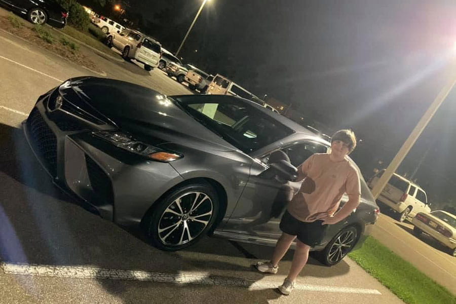 Hunter posing with his car