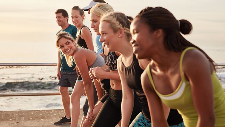 Group of multi-ethnic young adults starting a race on the beach