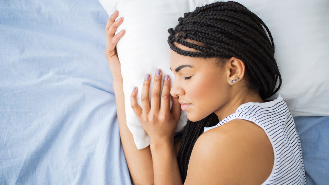 African American woman with braids sleeping