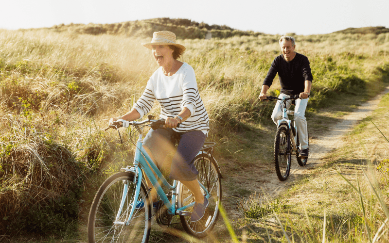 Couple riding bikes in nature-no logo