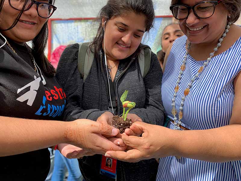 Ana Yris Guzmán (right) with students at Nuestra Escuela. (Photo courtesy of Nuestra Escuela)