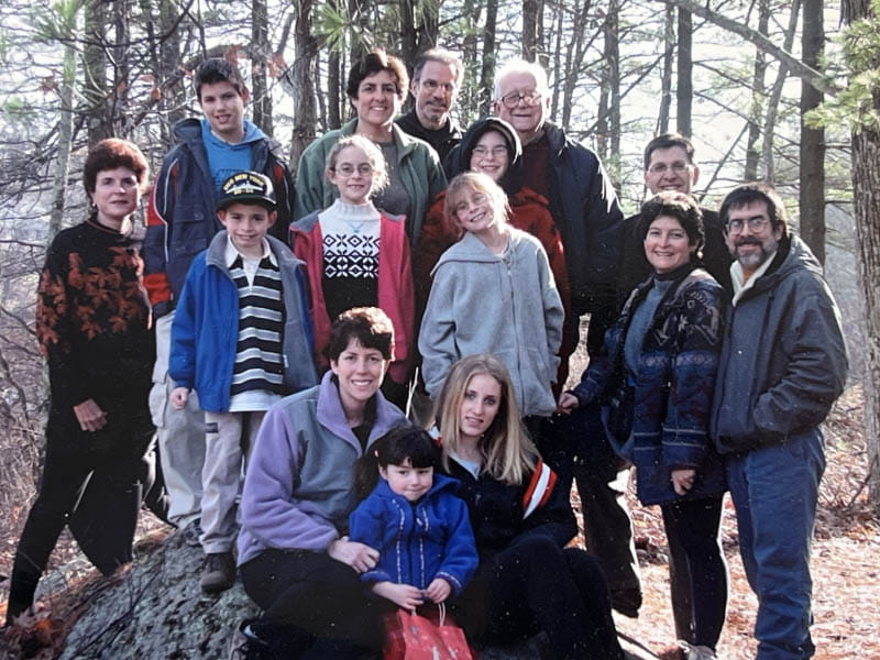 Dr. Eugene Braunwald (back row, right) with his daughters, their spouses and children, and his wife, Elaine (far left), on Thanksgiving Day 2003. (Photo courtesy of the Braunwald family)