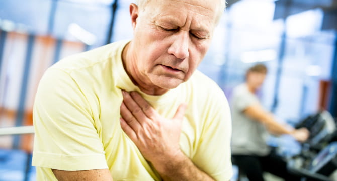 Older man clutching chest