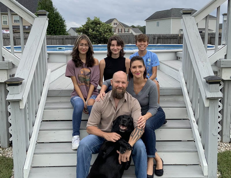 The Pharris family, clockwise from top left: Isabelle, Madison, Tristan, Jennifer and Jeff – who is holding his loyal black labrador, Murphy. (Photo courtesy of Jeff Pharris)