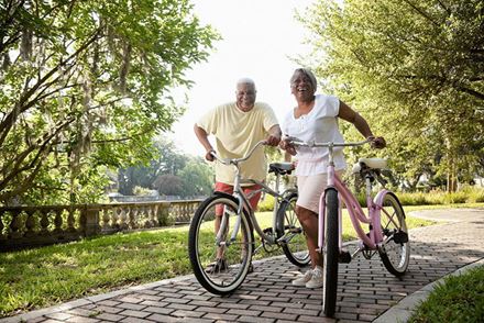 Senior couple riding bikes outdoors Senior couple riding bikes outdoors