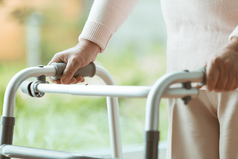 Senior person using a walker for balance