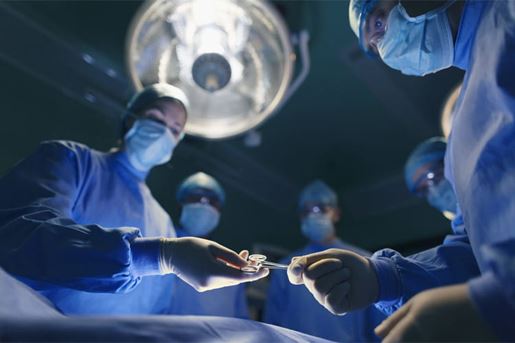 operating room staff performing surgery