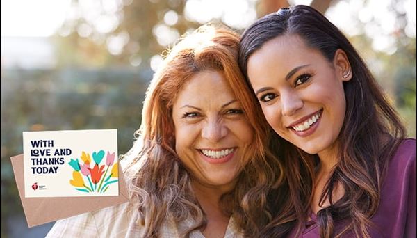 Two women smiling for the camera with eCard logo
